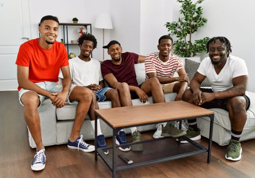 Group of african american people smiling happy sitting on the sofa at home.
